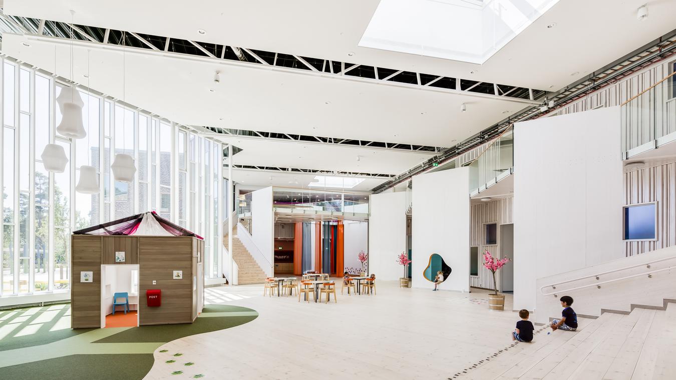 Large atrium with window surfaces and natural materials. Photo