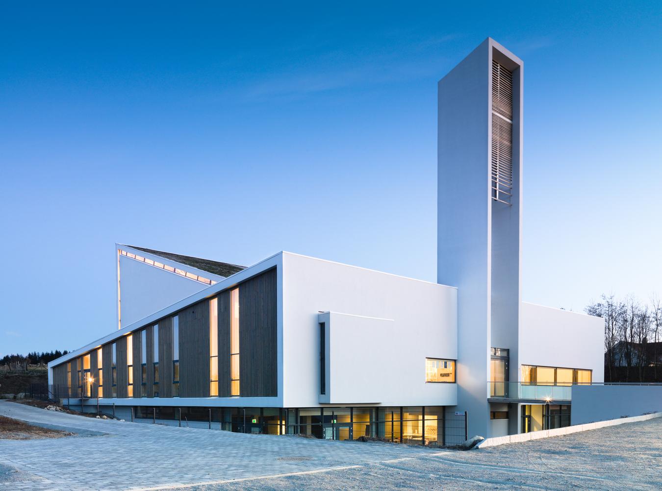 Sculptural facade and church tower in light stone. Photo