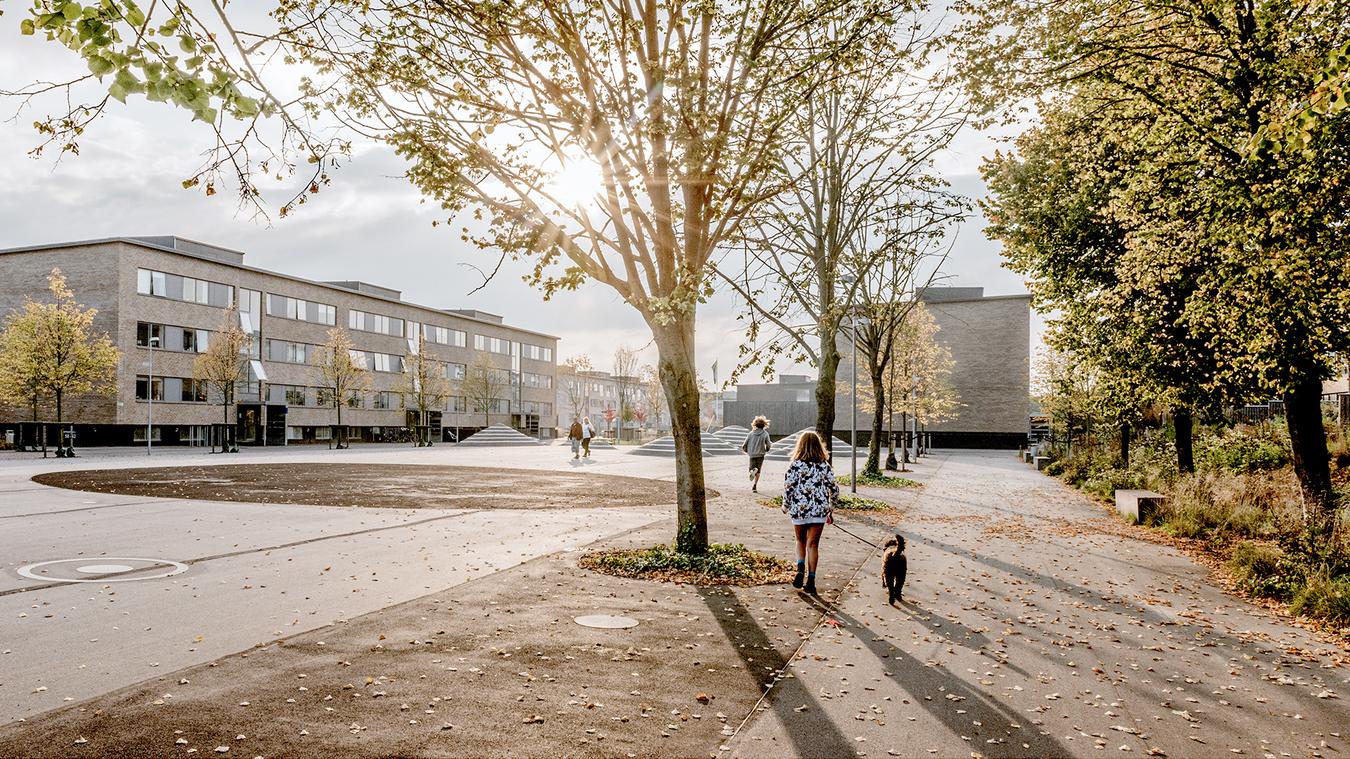 Children playing outside, in front of apartment blocks. Photo