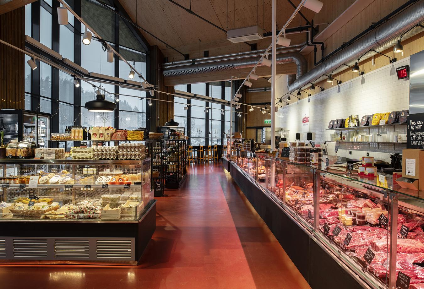 Red floor, fresh food counters and cafe table. Photo