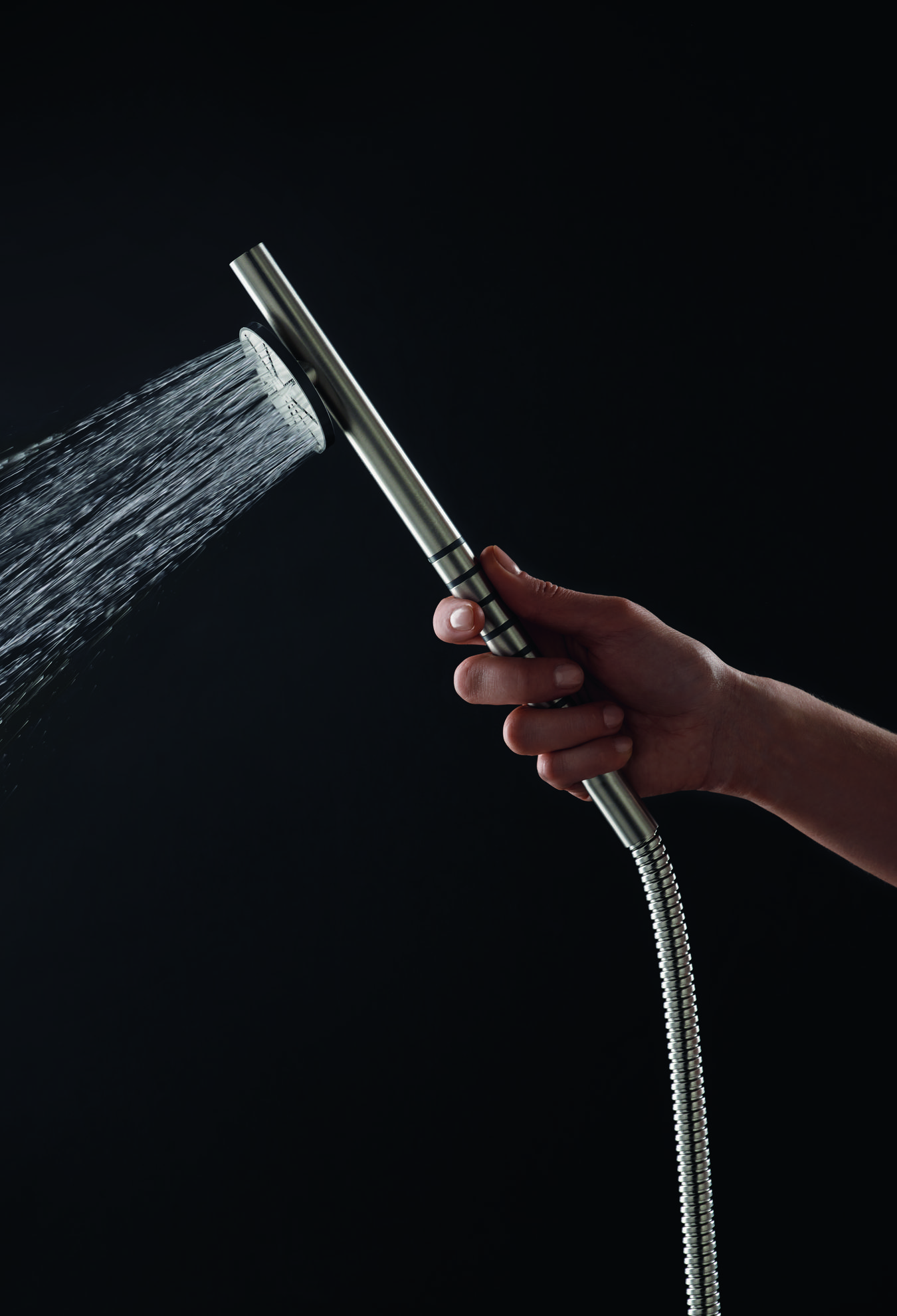 Person holding the shower head. Photo